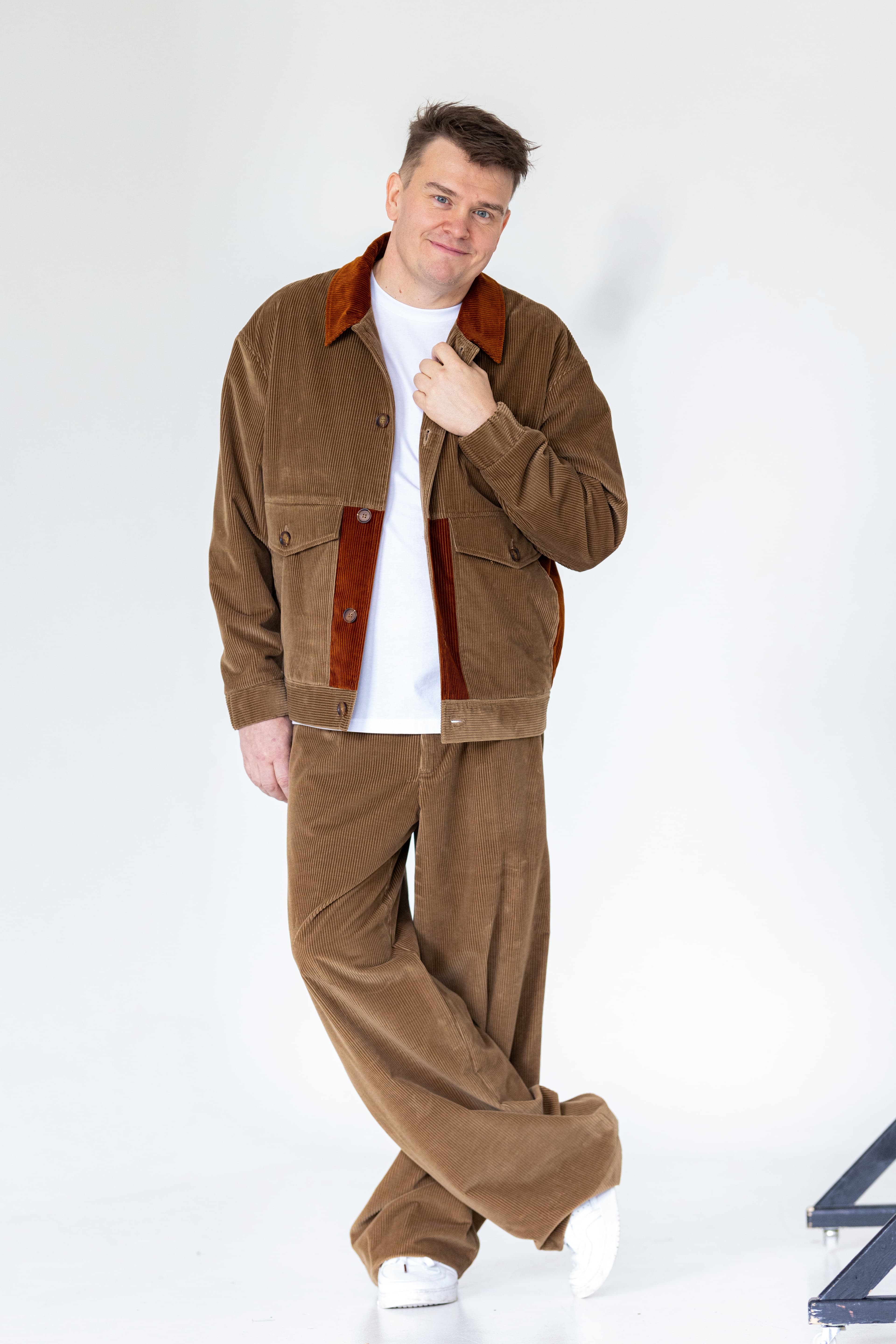 JP Pirinen walking outdoors in a brown jacket